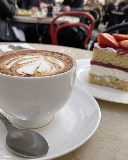 a cup of coffee and a piece of cake on a table